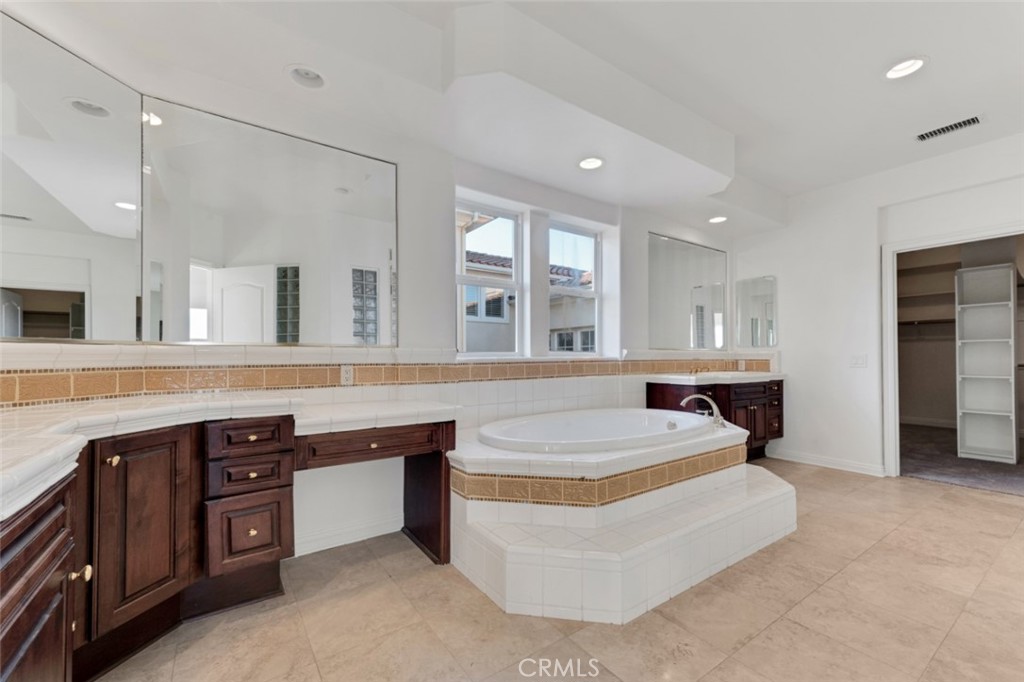 20212 Vía Medici Porter Ranch, CA 91326 - Photo 38 of 61 a spacious bathroom with a tub double sink and two mirror