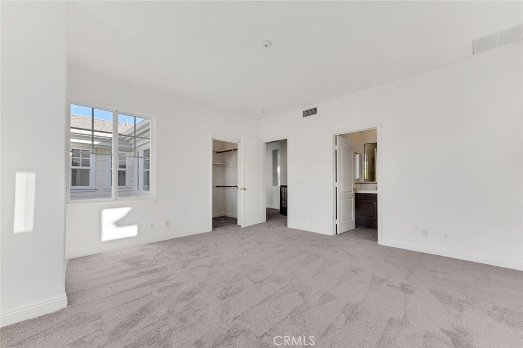 20212 Vía Medici Porter Ranch, CA 91326 - Photo 43 of 61 a view of an empty room with wooden floor and kitchen