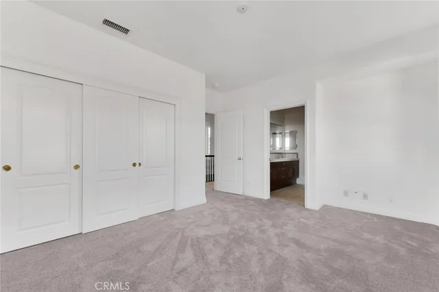 a view of a swimming pool with a yard and large tree