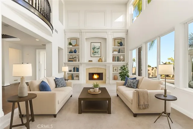 a living room with furniture fireplace and a large window