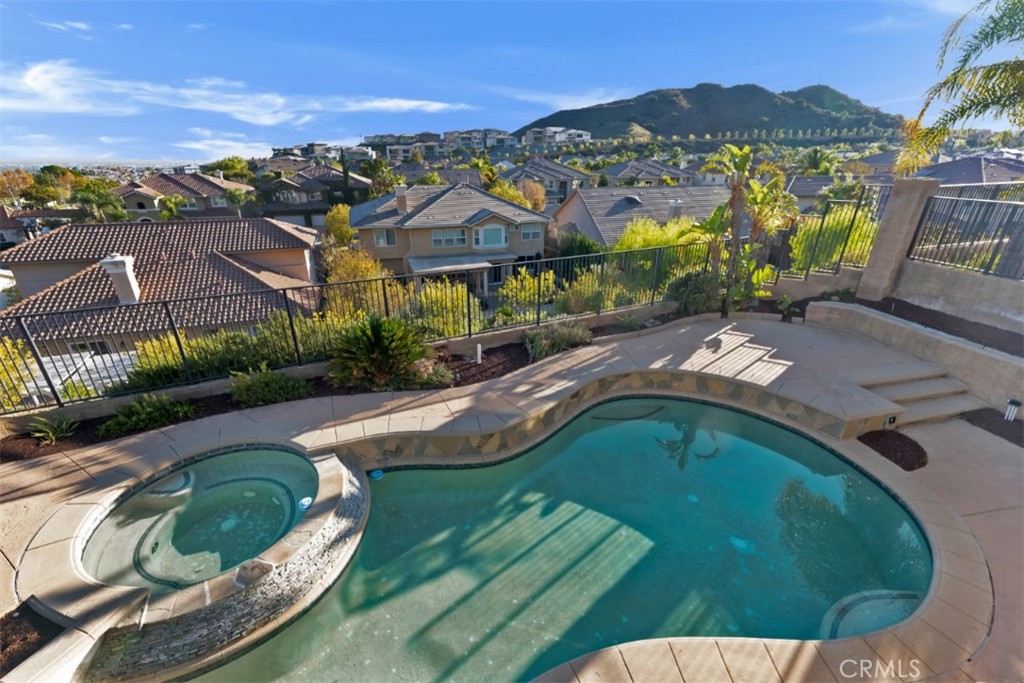 20212 Vía Medici Porter Ranch, CA 91326 - Photo 57 of 61 a view of a swimming pool with a yard and large tree
