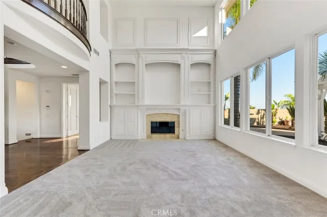 a view of a livingroom with an empty space and a fireplace