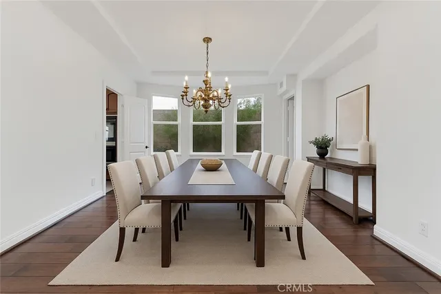 a view of a dining room with furniture wooden floor and chandelier