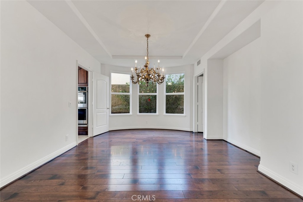 20212 Vía Medici Porter Ranch, CA 91326 - Photo 9 of 61 a view of an empty room with window and wooden floor