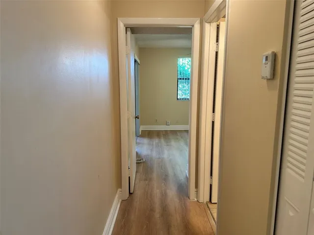 a view of a hallway with wooden floor
