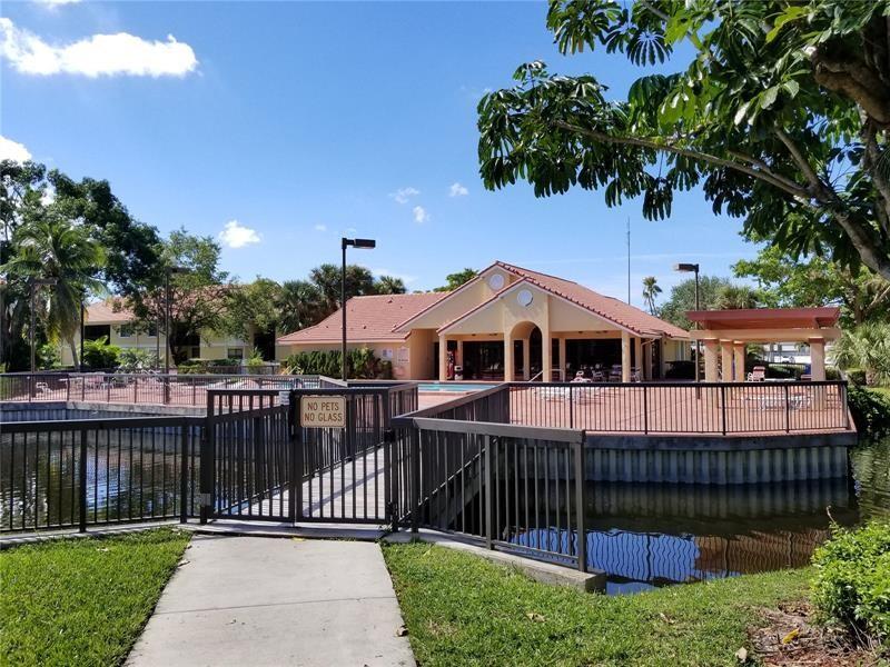5661 Riverside Drive, Unit 202 Coral Springs, FL 33067 - Photo 18 of 25 a front view of a house with a garden