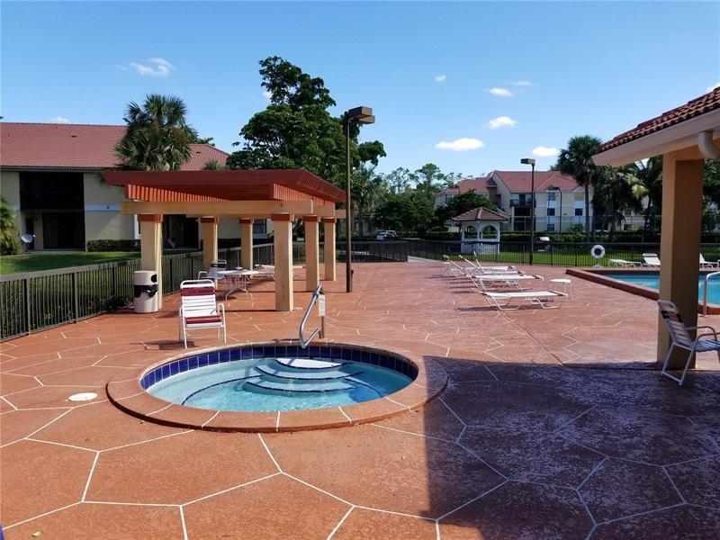 5661 Riverside Drive, Unit 202 Coral Springs, FL 33067 - Photo 21 of 25 a swimming pool with outdoor seating
