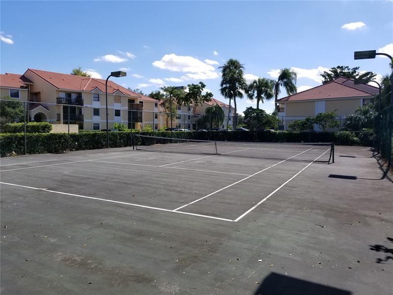 5661 Riverside Drive, Unit 202 Coral Springs, FL 33067 - Photo 22 of 25 a view of a tennis court