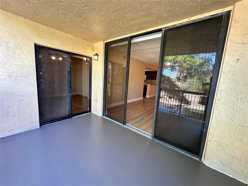 5661 Riverside Drive, Unit 202 Coral Springs, FL 33067 - Photo 4 of 25 an empty room with large window and front door