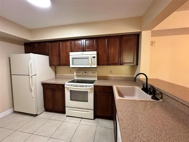 a kitchen with a refrigerator sink and stove
