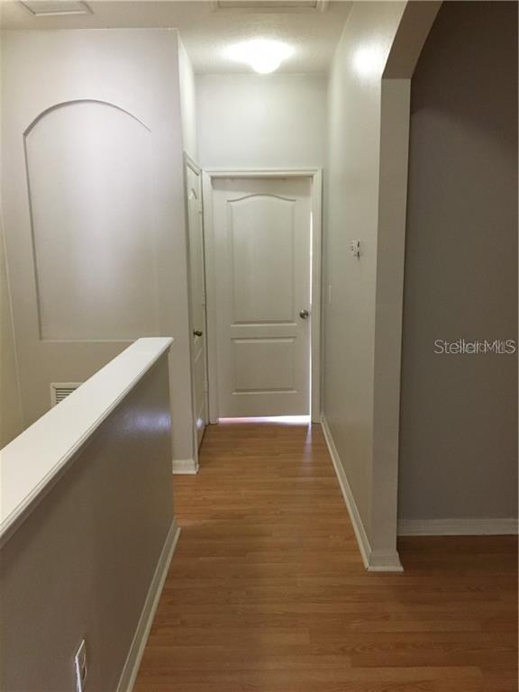 3426 High Hampton Circle Tampa, FL 33610 - Photo 11 of 27 a view of an empty room with wooden floor