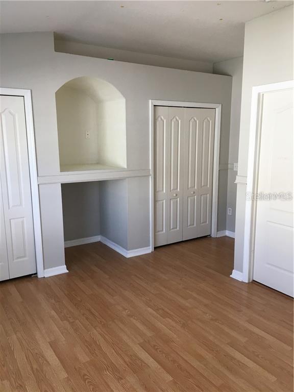 3426 High Hampton Circle Tampa, FL 33610 - Photo 15 of 27 an empty room with wooden floor and closet