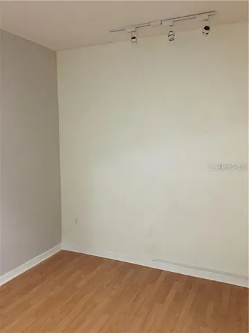 a bathroom with a granite countertop toilet sink and mirror