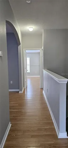 a view of hallway with wooden floor