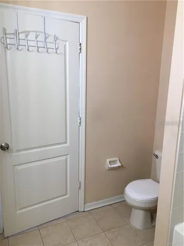 an empty room with sliding door and wooden floor