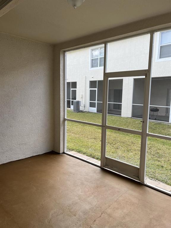3426 High Hampton Circle Tampa, FL 33610 - Photo 23 of 27 an empty room with sliding door and wooden floor