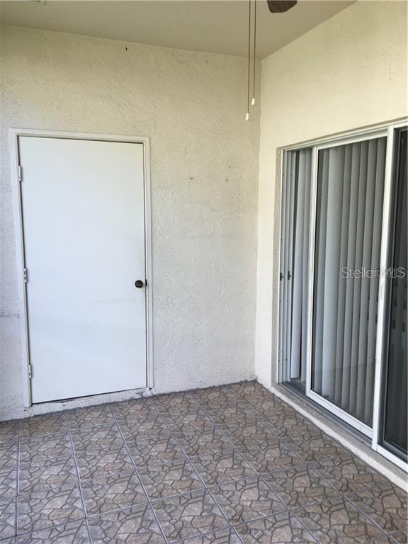 3426 High Hampton Circle Tampa, FL 33610 - Photo 24 of 27 a view of a room with a wooden door