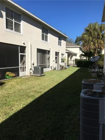 a view of house with yard and green space