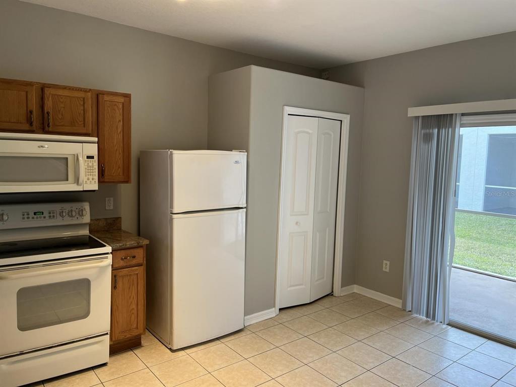 3426 High Hampton Circle Tampa, FL 33610 - Photo 7 of 27 a kitchen with a refrigerator sink stove and cabinets