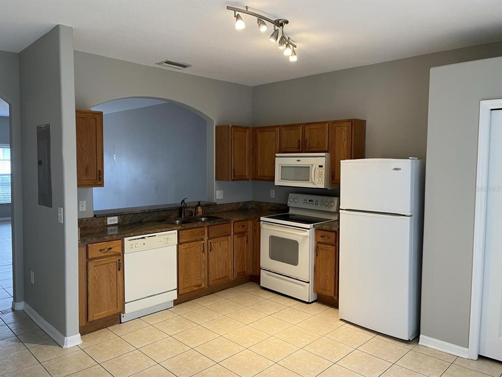 3426 High Hampton Circle Tampa, FL 33610 - Photo 8 of 27 a kitchen with granite countertop cabinets stainless steel appliances and a counter space