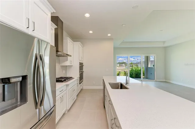 a kitchen with stainless steel appliances a refrigerator and a counter space