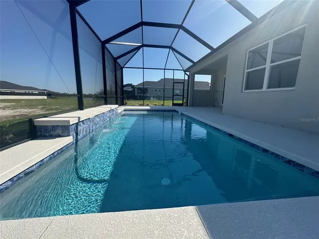a view of a swimming pool with a patio