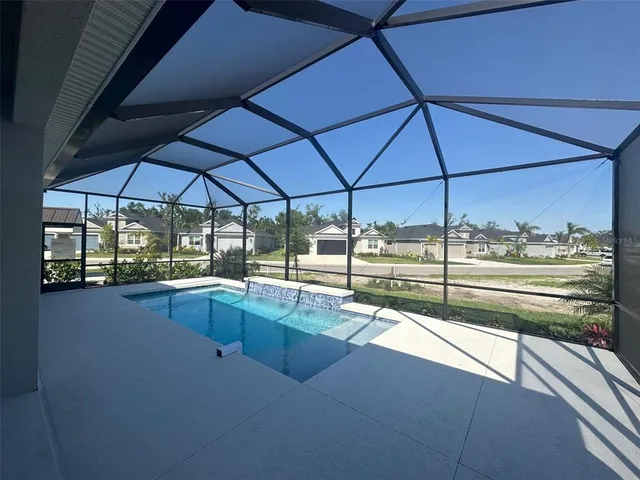 a view of a living room with a floor to ceiling window and an umbrella
