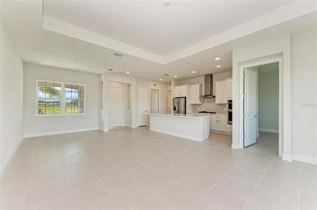 a view of a kitchen with white cabinets and a sink