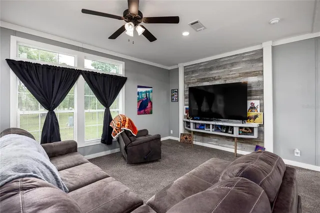 a kitchen with stainless steel appliances granite countertop a stove a sink a microwave a dining table and chairs with wooden floor