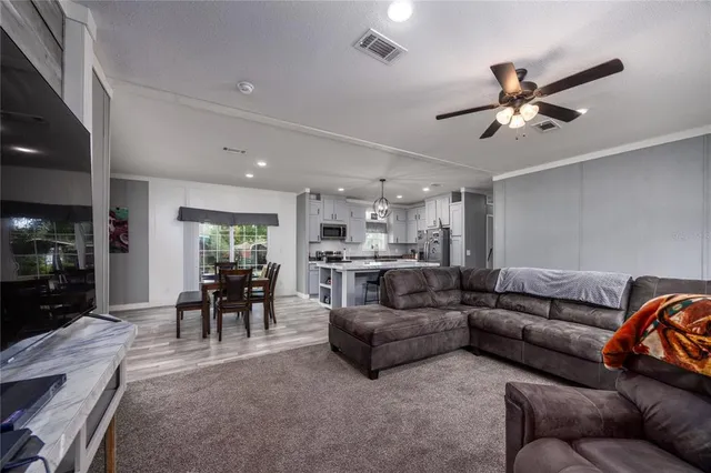 a kitchen with stainless steel appliances granite countertop a sink refrigerator and microwave