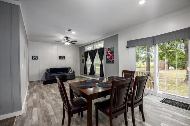 a living room with furniture and a ceiling fan