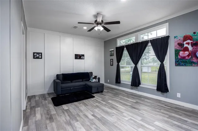 a spacious bedroom with a bed and a chandelier