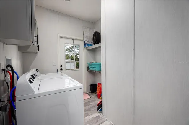 a view of a house with backyard and a tree