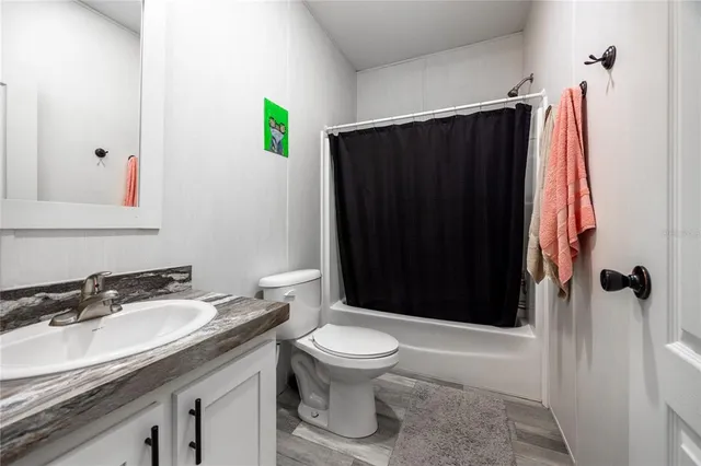 a backyard of a house with a table and chairs