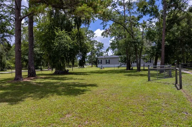 a backyard of a house with lots of green space