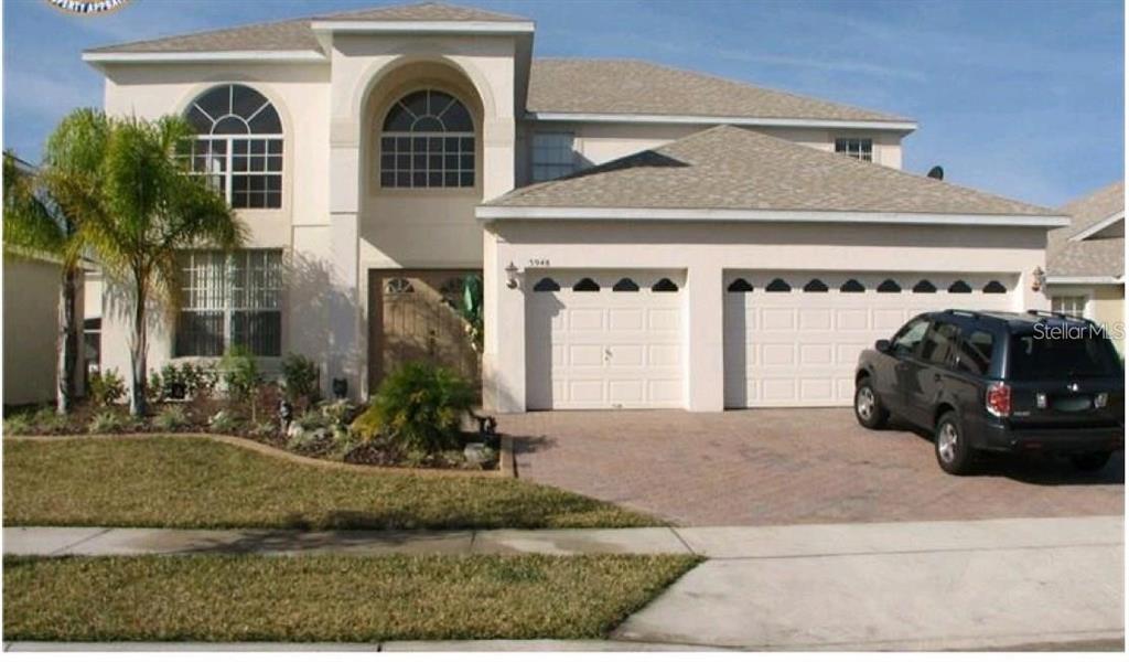 5948 Winchester Isle Road Orlando, FL 32829 - Photo 1 of 23 a front view of a house with garden