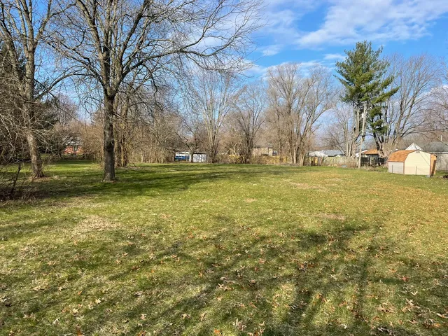 a view of a field with an trees