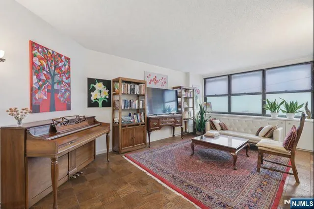 a bathroom with a granite countertop sink a mirror and a toilet