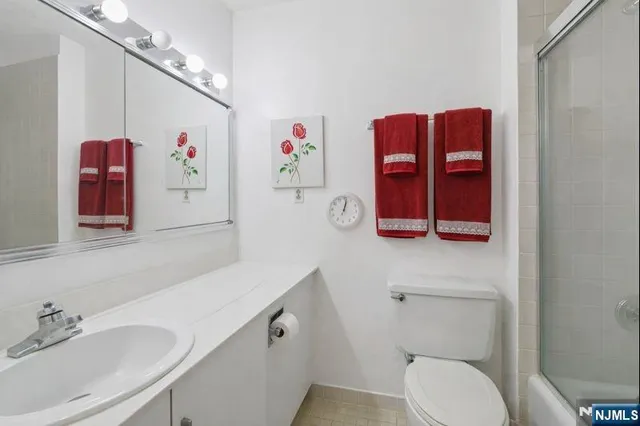 a bathroom with a sink a mirror and a shower