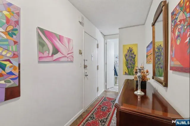 a room with painting on the wall and a table