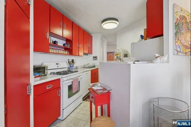 a kitchen with a sink stove and microwave