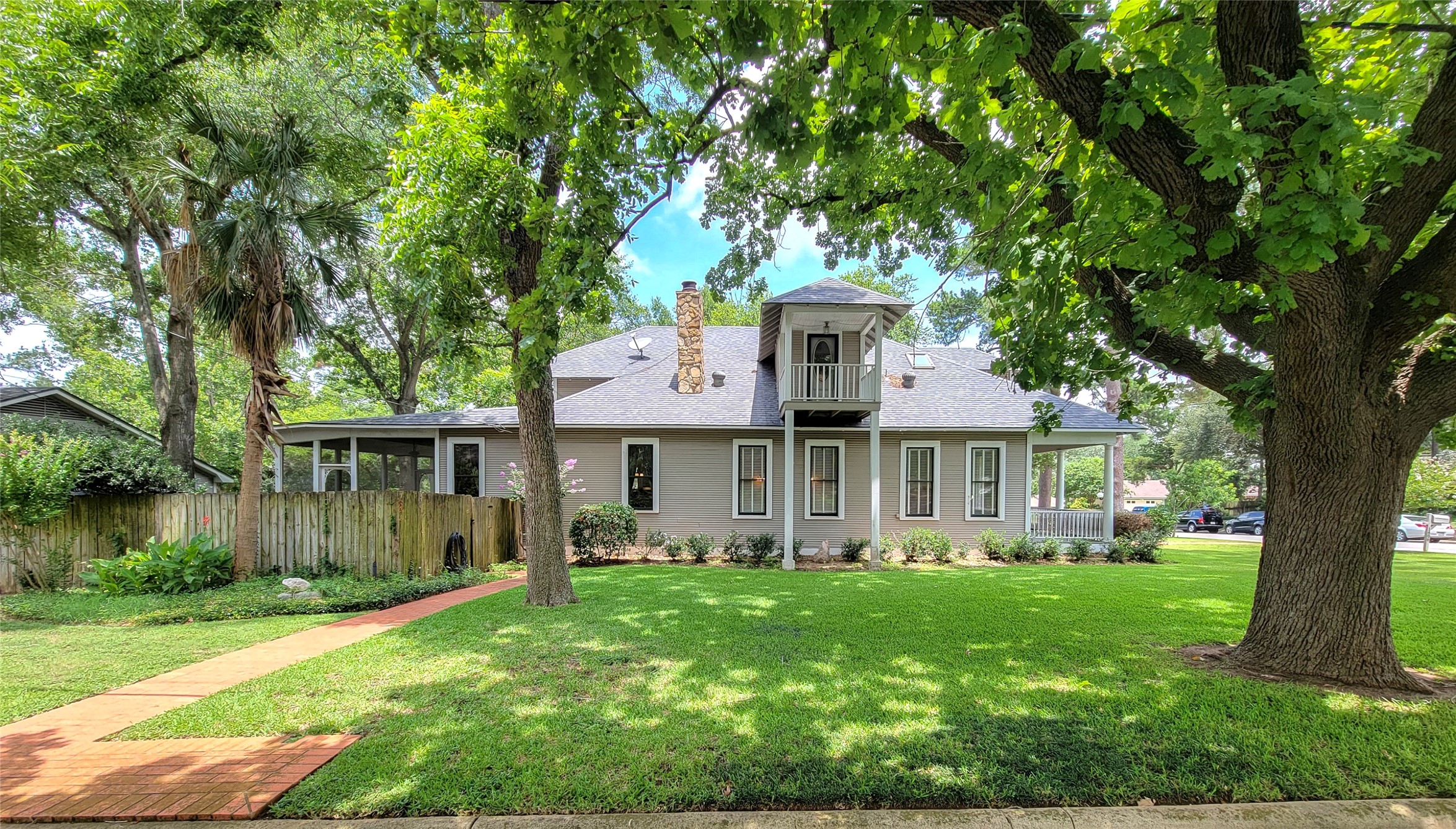 1406 Key Street Brenham, TX 77833 - Photo 3 of 50 Expansive .97-acre lot featuring lush landscaping and majestic century-old oak trees, complete with a water sprinkler system for easy maintenance.