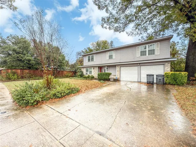 a front view of a house with a yard and a garage