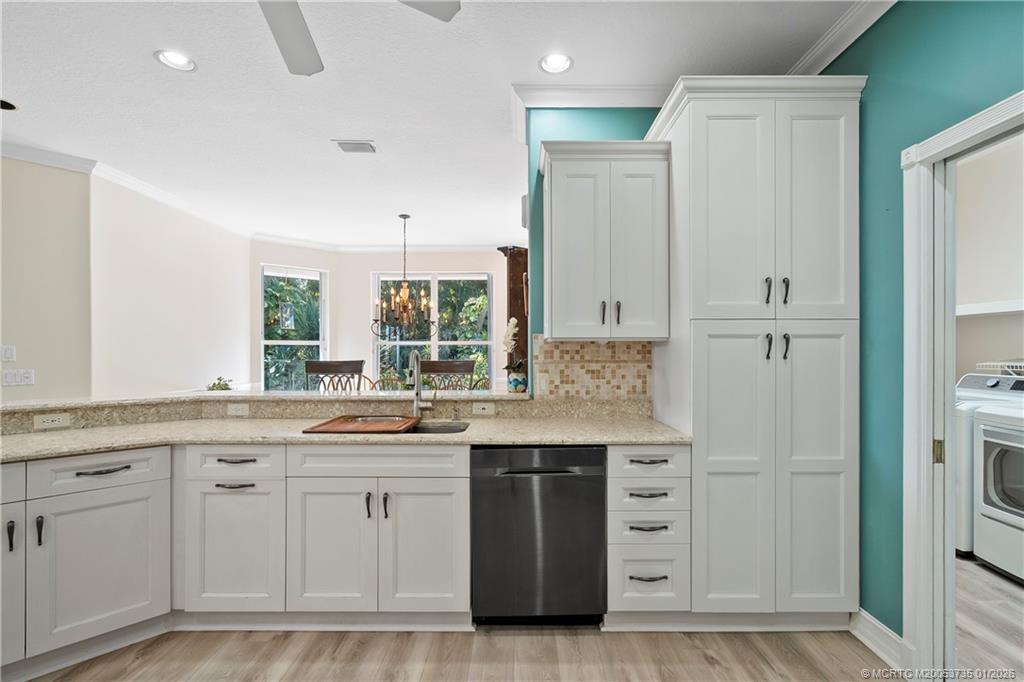 4 Lantana Lane Sewall's Point, FL 34996 - Photo 13 of 47 a kitchen with white cabinets and sink