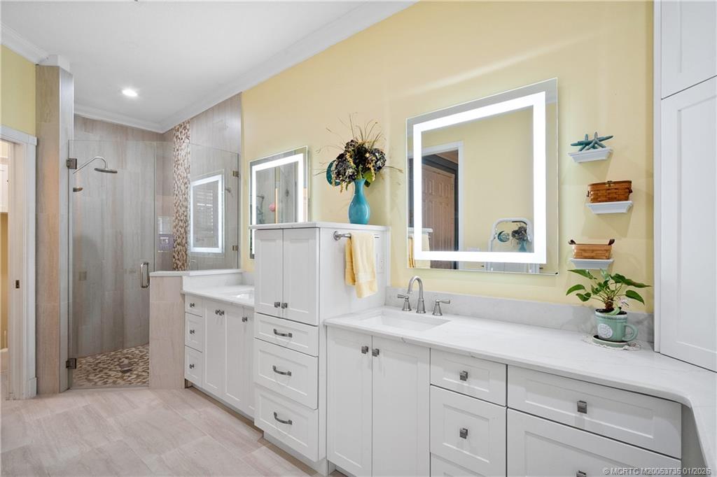 4 Lantana Lane Sewall's Point, FL 34996 - Photo 19 of 47 a spacious bathroom with double sink and a mirror