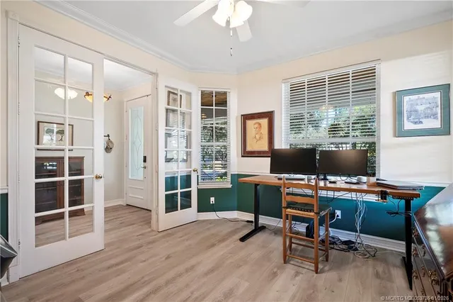 a view of a workspace with furniture and a window