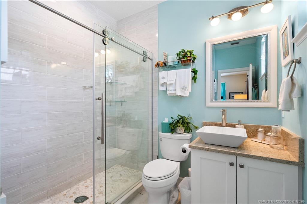 4 Lantana Lane Sewall's Point, FL 34996 - Photo 25 of 47 a bathroom with a granite countertop sink toilet and shower