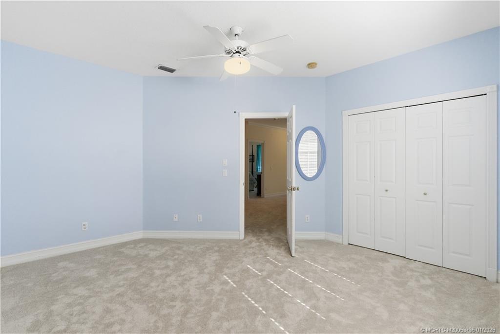 4 Lantana Lane Sewall's Point, FL 34996 - Photo 30 of 47 a view of an empty room with window and a ceiling fan