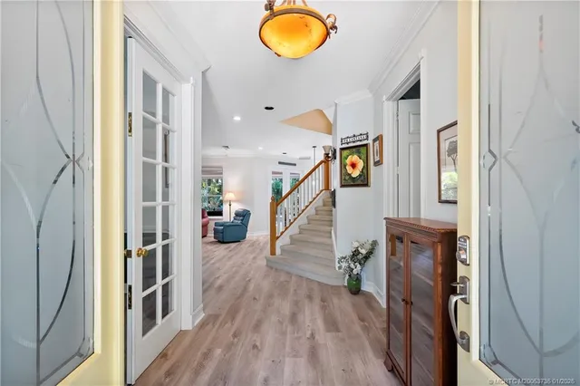 a view of entryway and hall with wooden floor