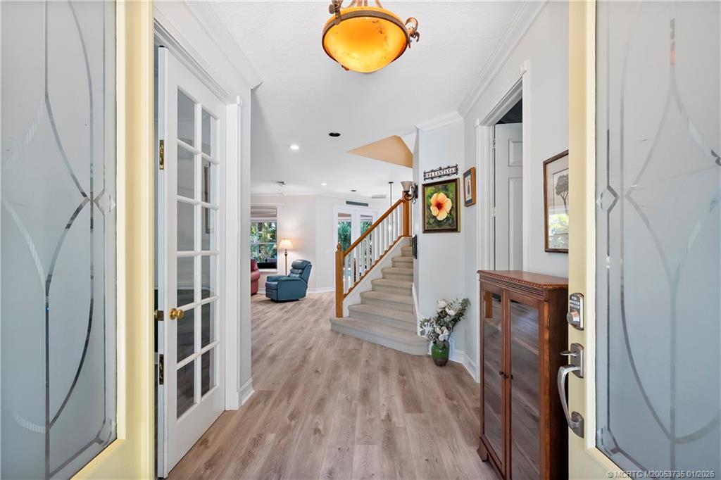 4 Lantana Lane Sewall's Point, FL 34996 - Photo 4 of 47 a view of entryway and hall with wooden floor